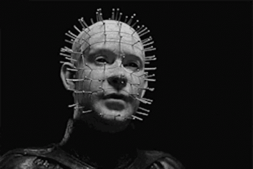 A Black And White Photo Of A Man With Nails In His Head And The Words " Your Holes Apart " GIF
