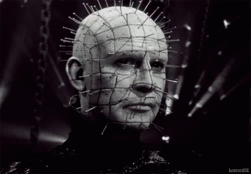 a black and white photo of a man with pins in his head