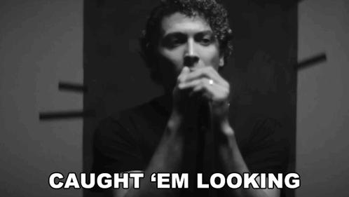 A Black And White Photo Of A Man With The Words Caught ' Em Looking ' On The Bottom GIF