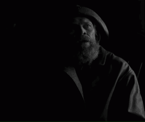 A Black And White Photo Of A Man With The Words How Long Have We Been On This Rock Below Him GIF