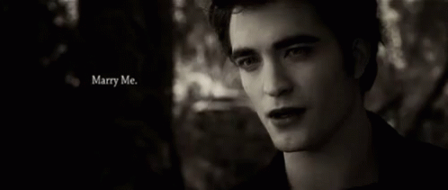 A Black And White Photo Of A Man With The Words Marry Me Written Above Him GIF
