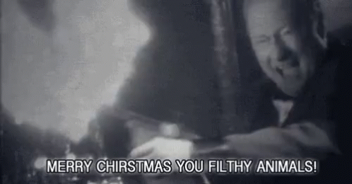 A Black And White Photo Of A Man With The Words `` Merry Christmas You Filthy Animals '' Written On The Bottom . GIF