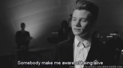 A Black And White Photo Of A Man With The Words Somebody Make Me Aware Of Being Alive Below Him GIF