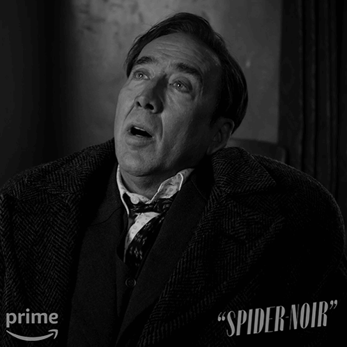 A Black And White Photo Of A Man With The Words " Spider Noir " On The Bottom Right GIF