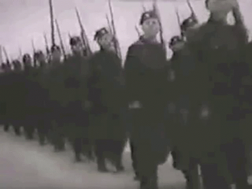 A Black And White Photo Of A Military Parade With Soldiers Marching In A Line . GIF