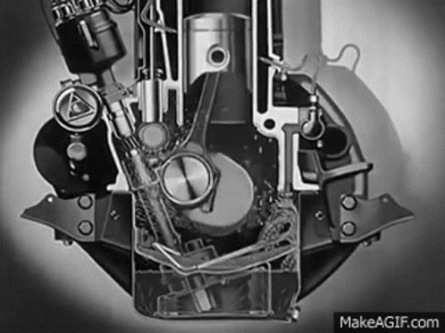 A Black And White Photo Of A Motorcycle Engine With Water Coming Out Of It . GIF