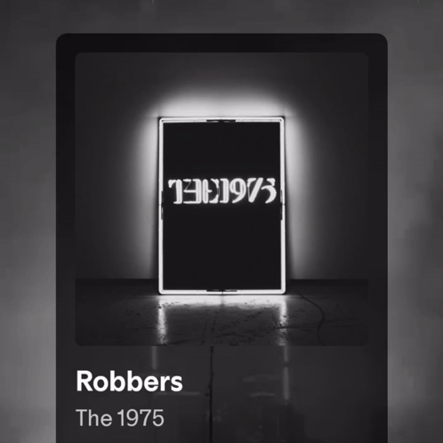 A Black And White Photo Of A Neon Sign That Says Robbers The 1975 GIF