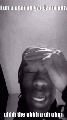 A Black And White Photo Of A Person Covering Their Face With Their Hand . GIF
