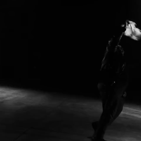 A Black And White Photo Of A Person Dancing In Front Of A Row Of Speakers GIF