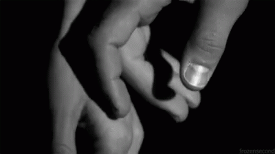 A Black And White Photo Of A Person Holding Another Person 'S Hand . GIF