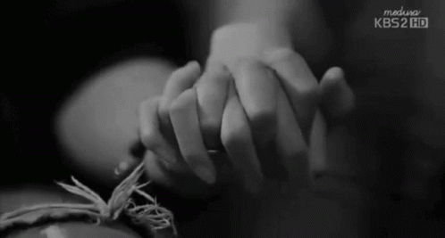 A Black And White Photo Of A Person Holding Another Person 'S Hand With Kbs2 Hd Written On The Bottom GIF