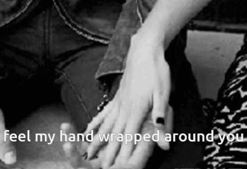 A Black And White Photo Of A Person Holding Another Person 'S Hand With The Caption " Feel My Hand Wrapped Around You " GIF
