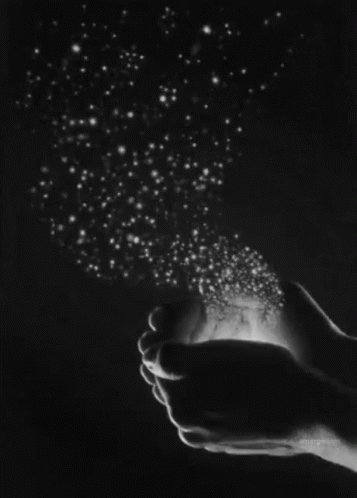 A Black And White Photo Of A Person Holding Stars In Their Hands . GIF