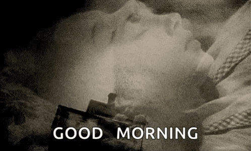 A Black And White Photo Of A Person Laying In A Bed With The Words `` Good Morning '' Written In The Corner . GIF