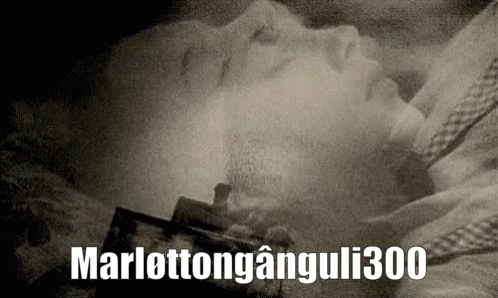 A Black And White Photo Of A Person Laying In A Coffin With The Words Marlottonganguli300 Above It GIF