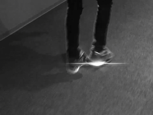 A Black And White Photo Of A Person Laying On The Floor With Their Head Down . GIF