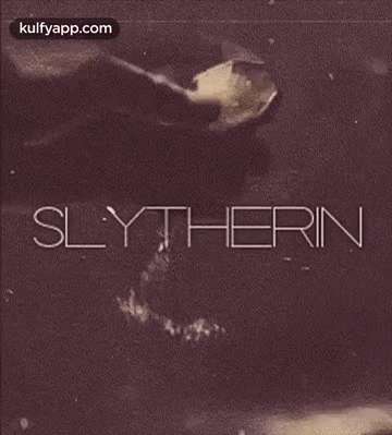 A Black And White Photo Of A Person Pouring Something Into A Glass With The Word Slytherin On It . GIF