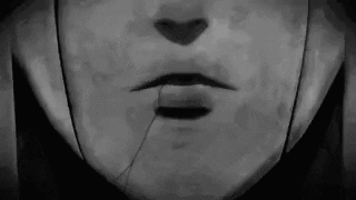 a black and white photo of a person 's face with a broken nose and mouth .