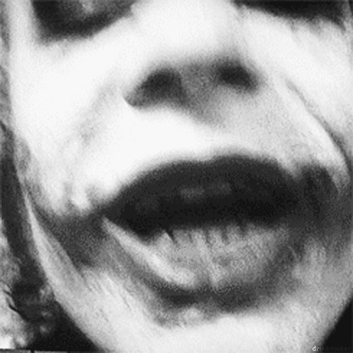 A Black And White Photo Of A Person 'S Face With Their Mouth Open And Their Tongue Sticking Out . GIF
