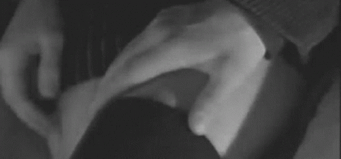 A Black And White Photo Of A Person 'S Hand On A Woman 'S Leg . GIF