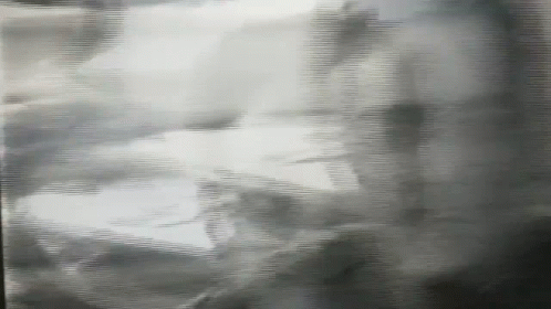 A Black And White Photo Of A Person 'S Shadow On A Wall GIF