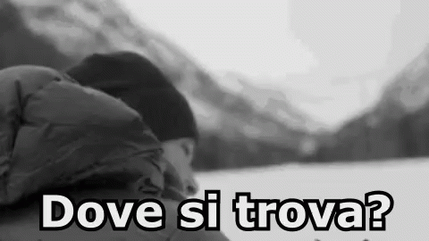 A Black And White Photo Of A Person Sleeping In The Snow With The Words `` Dove Si Trova '' Written On The Bottom . GIF