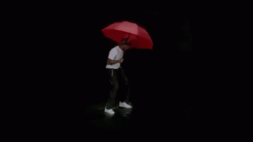 A Black And White Photo Of A Person Standing In The Water . GIF
