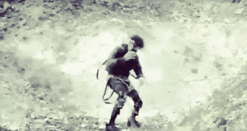 A Black And White Photo Of A Person Walking GIF