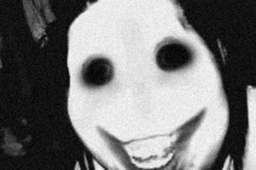 A Black And White Photo Of A Person With A Scary Face And Black Eyes Smiling . GIF