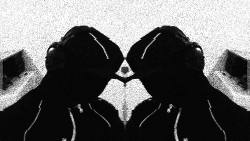 A Black And White Photo Of A Person With Headphones On GIF