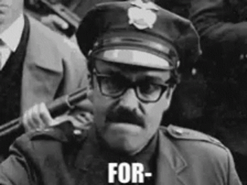 A Black And White Photo Of A Police Officer Holding A Gun And The Words For Written On His Face GIF