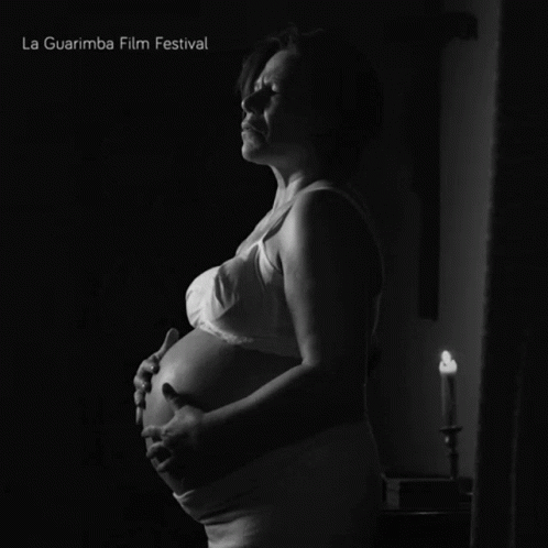 A Black And White Photo Of A Pregnant Woman With La Guarimba Film Festival Written On The Bottom GIF