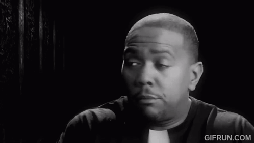 A Black And White Photo Of A Priest Making A Face GIF