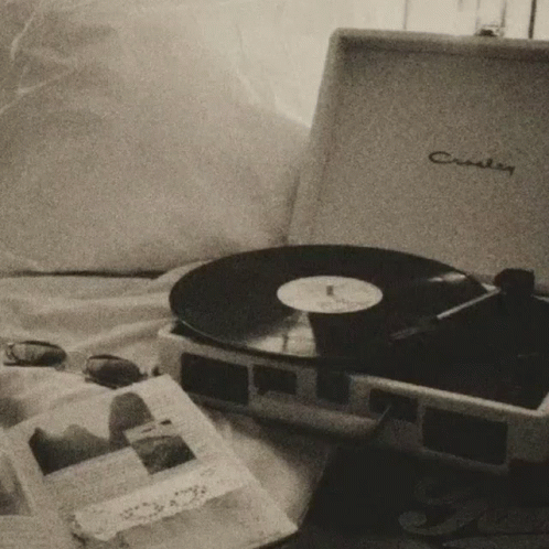 A Black And White Photo Of A Record Player That Says Crosley GIF