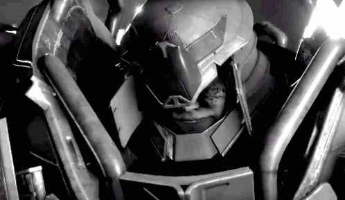 A Black And White Photo Of A Robot Wearing A Helmet And Armor . GIF
