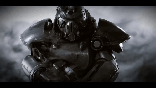 A Black And White Photo Of A Robot With A Helmet That Has The Letter T On It GIF