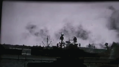 a black and white photo of a ship in the water with smoke coming out of it
