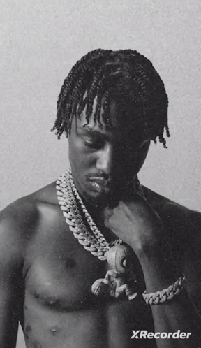 A Black And White Photo Of A Shirtless Man Holding A Teddy Bear With Xrecorder Written On The Bottom GIF