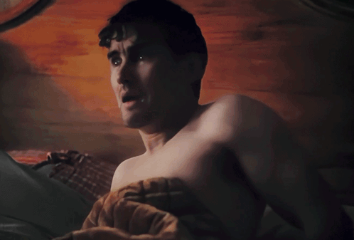 A Black And White Photo Of A Shirtless Man With Cartoon Eyes On His Face GIF