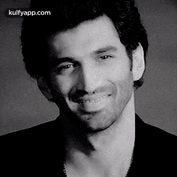 A Black And White Photo Of A Smiling Man . GIF