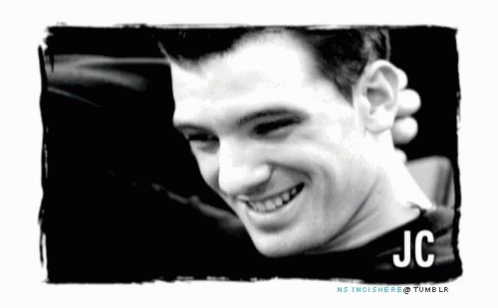 A Black And White Photo Of A Smiling Man With The Name Jc GIF