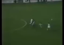 A Black And White Photo Of A Soccer Game With A Goalie In The Background . GIF