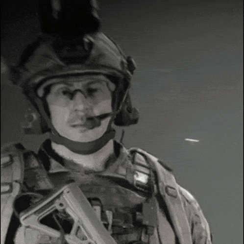 Black And White Photo Of Soldier With Helmet And Gun GIF