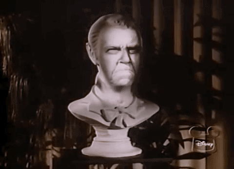 A Black And White Photo Of A Statue Of A Man With A Disney Logo On The Corner GIF