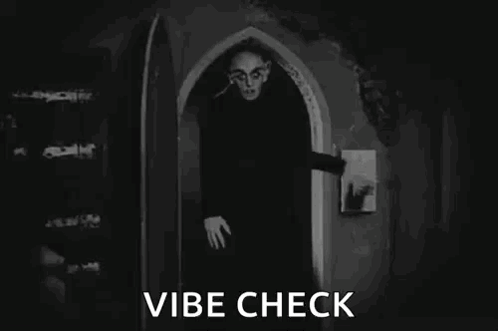 A Black And White Photo Of A Vampire In A Doorway . GIF