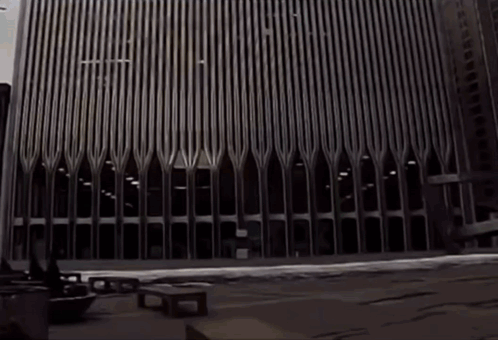 A Black And White Photo Of A Very Tall Building With The Letters Ec On It GIF