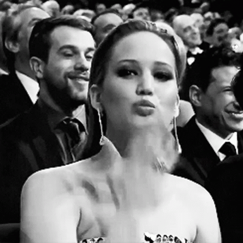 Black And White Woman Blowing Kiss In Crowd GIF