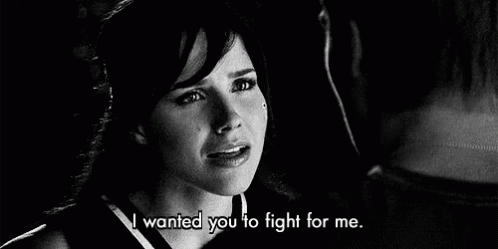 A Black And White Photo Of A Woman Crying Next To A Man . GIF
