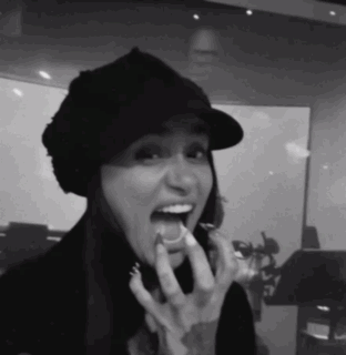 a black and white photo of a woman eating something
