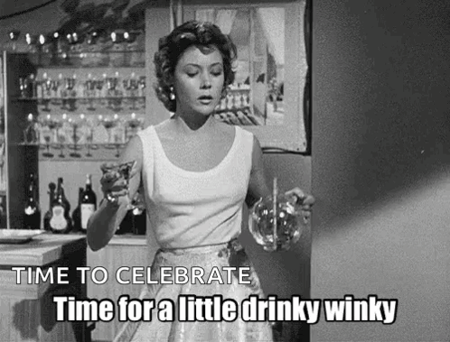 A Black And White Photo Of A Woman Holding A Glass Of Wine And A Pitcher . GIF